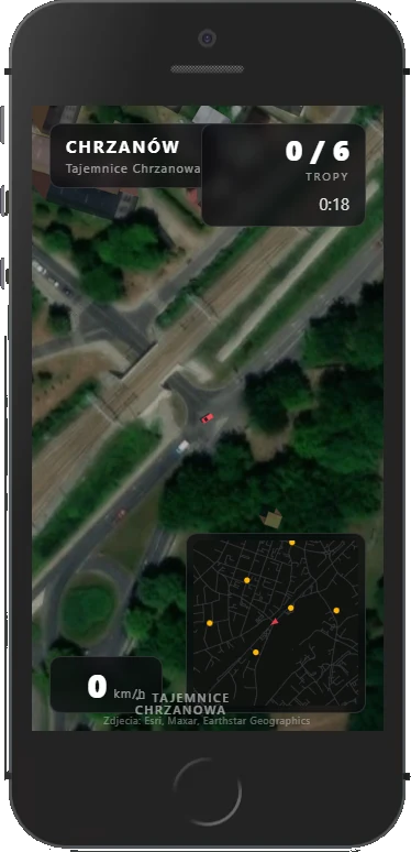 Przejazd po Chrzanowie na ekranie telefonu: widok z góry na skrzyżowanie przy torach, licznik tropów 0/6, czas 0:18 i minimapa miasta