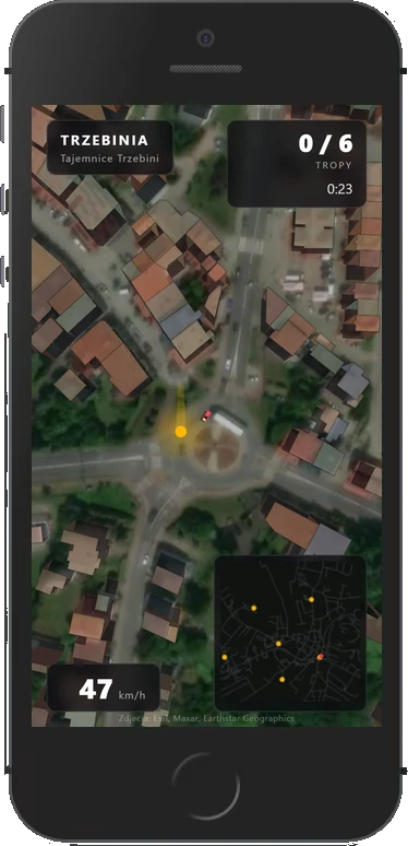 Przejazd po Trzebini na ekranie telefonu: widok z góry na rondo w środku miasta, licznik tropów 0/6, czas 0:23, prędkość 47 km/h i minimapa